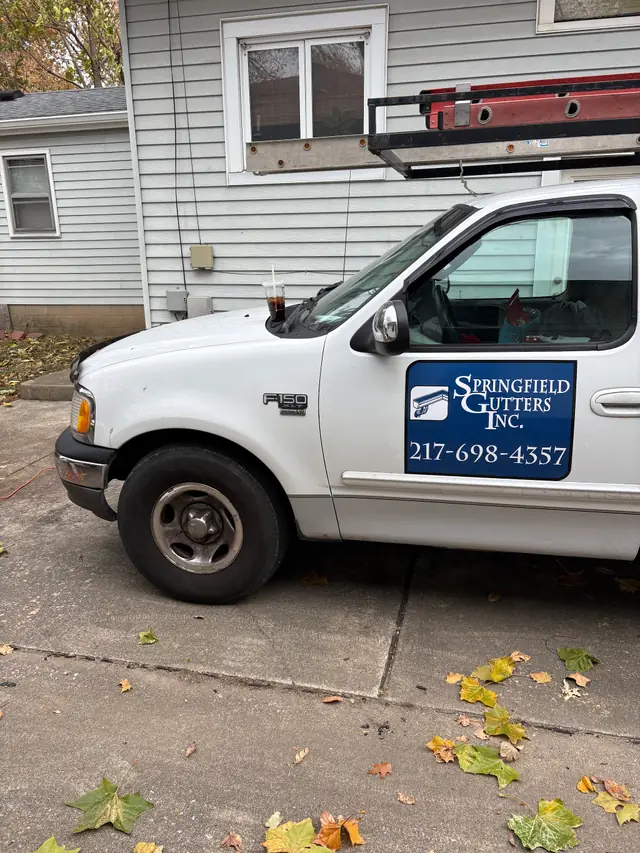 Springfield Gutters work truck with door signage and a loaded ladder rack